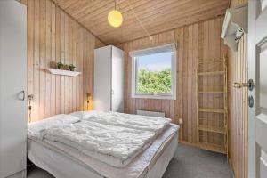 a bedroom with a bed in a room with a window at 0060-Romo-Lakolk-33 in Lakolk