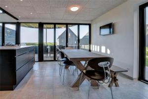 a dining room with a wooden table and chairs at 0374-Romo-Vestergade-337 in Sønderby