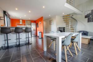 a kitchen and dining room with a white table and chairs at Chez mimi in Plessis-Barbuise