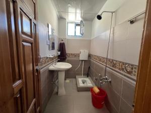 a small bathroom with a sink and a mirror at Karakoram Comfort Guest House in Khudābād