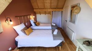 a small room with two beds in it at La morinière in Carantec
