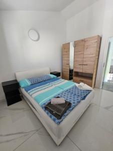 a bedroom with a large bed with blue sheets at Villa Carpe Diem in Vantačići