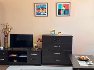 a living room with a dresser and a tv at Ski Lift Studio 531 in Bansko
