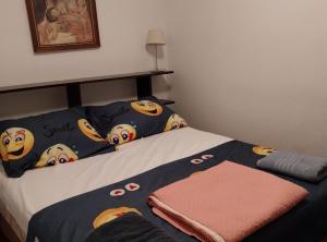 a bed with hello kitty pillows and a blanket at Apartment Modric in Senj