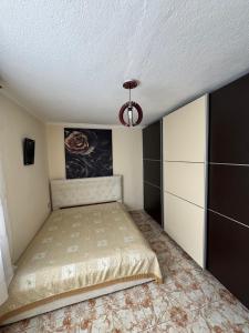 a bedroom with a bed and a ceiling at Central Stay Pogradec in Pogradec