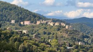 a group of buildings on top of a mountain at Maison de village in Stazzona