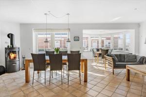 a living room with a table and chairs and a fireplace at 0381-Romo-Sonder-Frankel-44 in Havneby