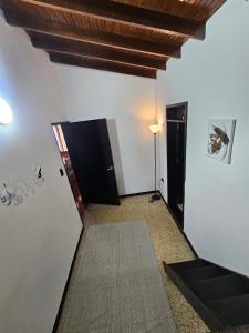 a hallway with white walls and a ceiling at Casa luz in Medellín