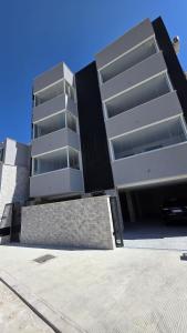 a building with a car parked in front of it at Raggio di Sole 5 P3 in Bari