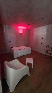 a room with a tub and a table and a pink light at Raggio di Sole 5 P3 in Bari