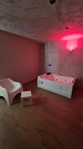 a room with a bed and a table and red lights at Raggio di Sole 5 P3 in Bari