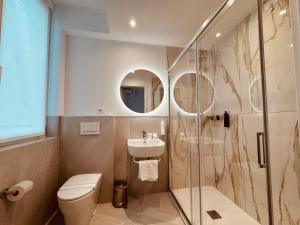 a bathroom with a toilet and a sink and a shower at Hotel Pex Verona in Verona
