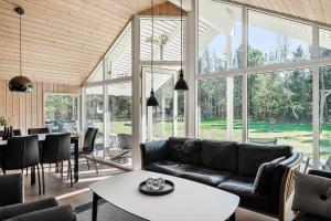 a living room with a couch and a table at 0120-Romo-Smafolksvej-61 in Kongsmark