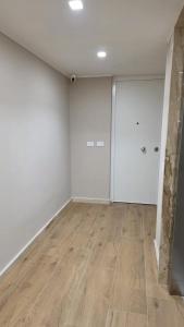 an empty room with white walls and wooden floors at Raggio di Sole 5 P4 in Bari