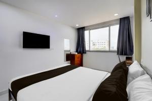 Postel nebo postele na pokoji v ubytování Hotel O PRAMOD GUEST INN