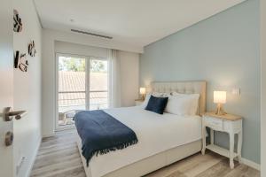Un dormitorio blanco con una cama y una ventana. en Paraty Villa, en Aroeira 39 fotos más