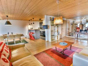 a living room with a couch and a table at Spacieux T4 proche des pistes avec terrasse et parking - 6-8 pers. - FR-1-685-22 in Les Gets