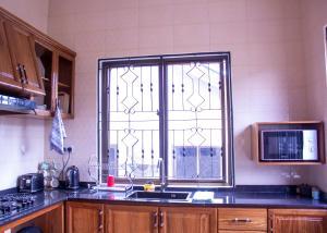 a kitchen with a sink and a window in it at Spacious 2 bedroom home with equipped kitchen in Dar es Salaam +5 photos