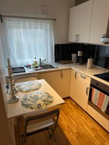 a kitchen with a table with two plates on it at Apartment Strömstad, Lökholmen in Strömstad +10 photos