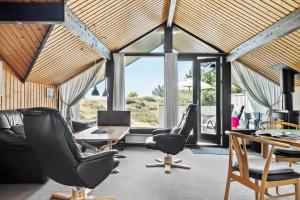 a living room with chairs and a table and windows at 0231-Romo-A-M-Listsvej-8 in Tagholm