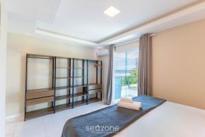 a bedroom with a bed and a large window at Apto c/ Vista Mar a 200m da Praia TSR0501 in Cururupe