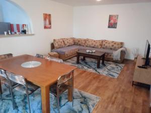 a living room with a table and a couch at Apartman Dane i Ivana Međugorje in Međugorje