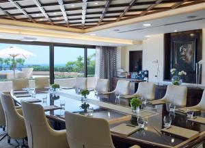 a conference room with a long table and white chairs at Four Seasons Hotel in Limassol