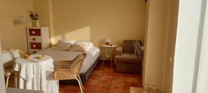 a bedroom with a bed and a chair and a table at Casa Del Sol La Herradura in La Herradura