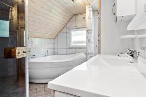 une salle de bain blanche avec une baignoire et un lavabo dans l'établissement 0142-Romo-Ivigtut-1, à Kongsmark 20 autres photos