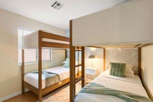 a bedroom with two bunk beds and a window at Reset Rally Pool Hot Tub Firepit in Casa Grande +52 photos