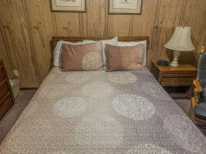 a bedroom with a large bed with pillows and a lamp at SC113A1BR 1BA Sleeps six WIFI Hot Tub Free Parking in Snowshoe