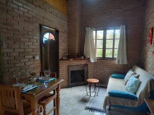 a living room with a couch and a fireplace at Chalé Vale das Flores - Visconde de Mauá Rj in Visconde De Maua