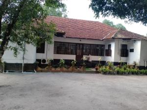 a white building with a red roof at Alleppey Tharavad in Alleppey