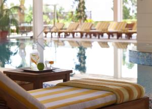 a table with a bottle of wine and a glass on it at Four Seasons Hotel in Limassol