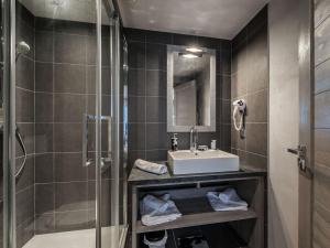 a bathroom with a sink and a shower at Appartement Raffiné à Courchevel Moriond, 4 Étoiles, Près des Remontées Mécaniques - FR-1-563-99 in Courchevel