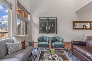 a living room with a couch and two chairs at Amazing mountain Views 3BR Penthouse with private Balconies in Canmore +37 photos