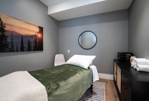 a bedroom with a bed and a mirror on the wall at Sitka Spruce Mountain Chalet in Revelstoke