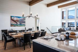 a dining room with a large table and chairs at Sitka Spruce Mountain Chalet in Revelstoke