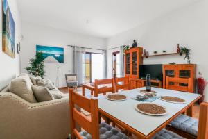 a living room with a table and chairs and a couch at Pool Retreat Tamaragua in La Oliva