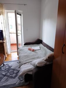 a bedroom with a bed with a red bottle on it at Stan Nex in Pljevlja +3 photos