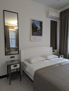a hotel room with a bed and a mirror at MARISS hotel & business in Kropyvnytskyi +47 photos