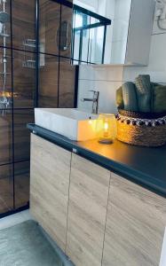 a bathroom with a sink and a counter with a lamp at Tivat Terrace Deluxe in Tivat