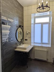 a bathroom with a sink and a mirror and a window at Gosudar Hotel in Kropyvnytskyi