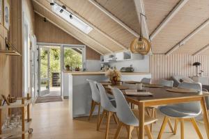 a kitchen and dining room with a table and chairs at 0153-Romo-Julianehab-5 in Kongsmark