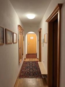 a hallway with a yellow door and a rug at Ferienwohnung Schanzenblick in Oberstdorf