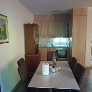 a kitchen with a table with a candle on it at Holiday House Ostrozac na Uni in Ostrožac