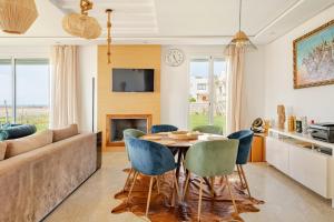 a living room with a table and chairs and a couch at Rabat Oceanfornt Luxury Villa Plage Val d Or in Temara