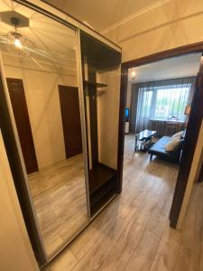 a living room with a large mirror and a living room at Harkovskaya 32 in Sumy