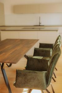 a wooden table with two chairs next to a table at Brück Residenz in Regensburg +21 photos