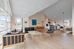 a living room with a couch and a table at 0257-Romo-Chresten-Krommes-Vej-9 in Tagholm
